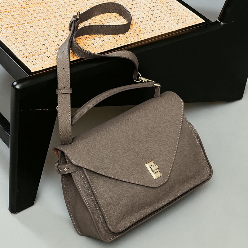 Togo Leather Top Handle Crossbody Bag Taupe with chair