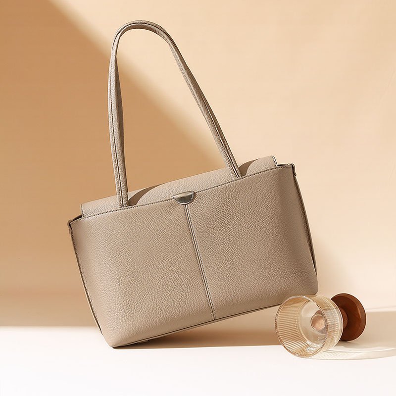 sloping Pebble Leather Large Tote Bag with Flap Beige with a wineglass